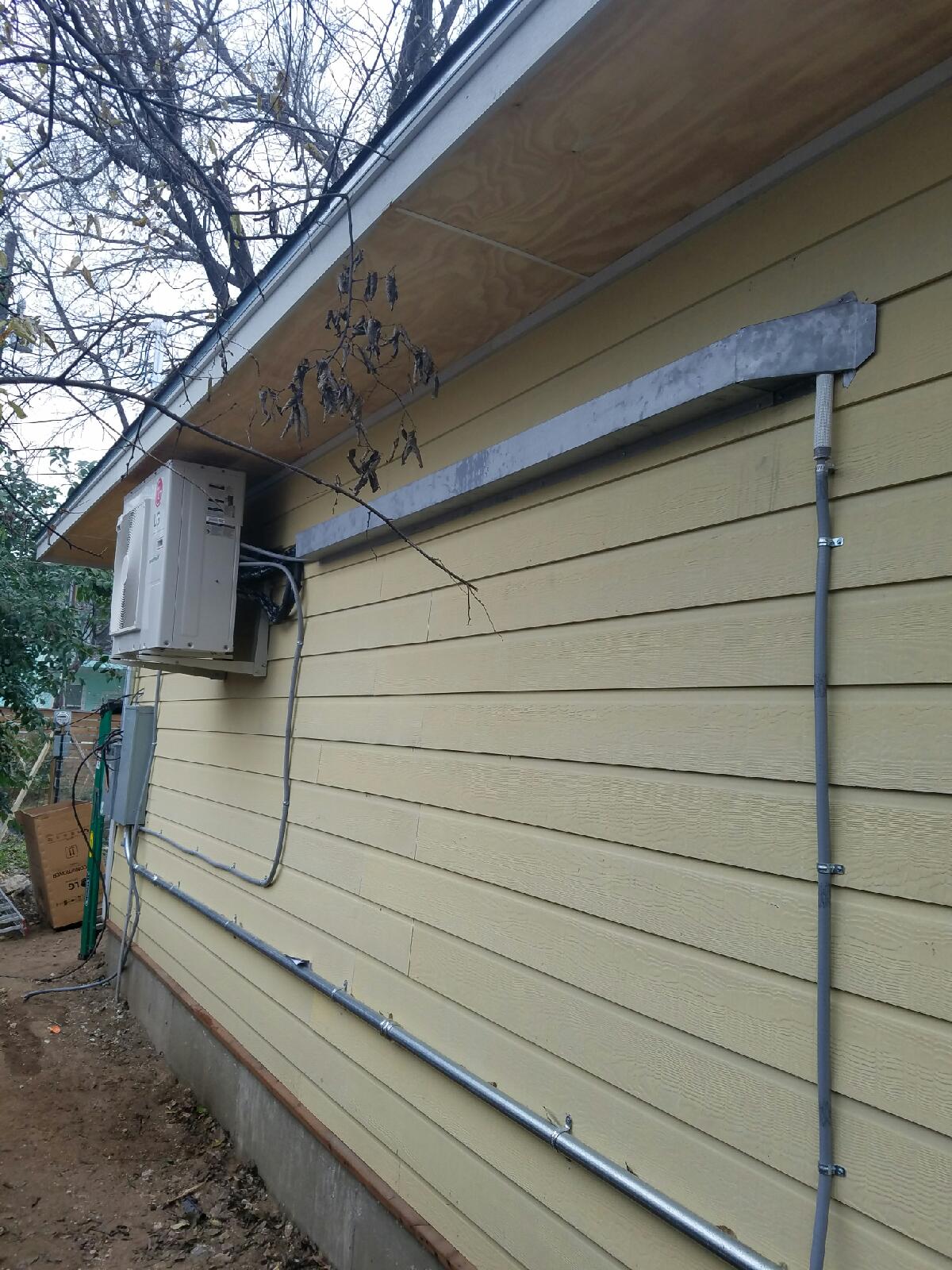 Outside of a home with a split AC mounted